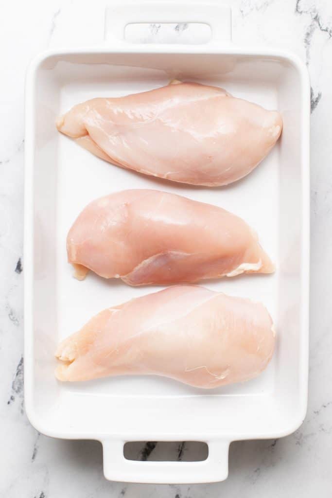 oven baked shawarma breast in a baking pan-raw chicken breast