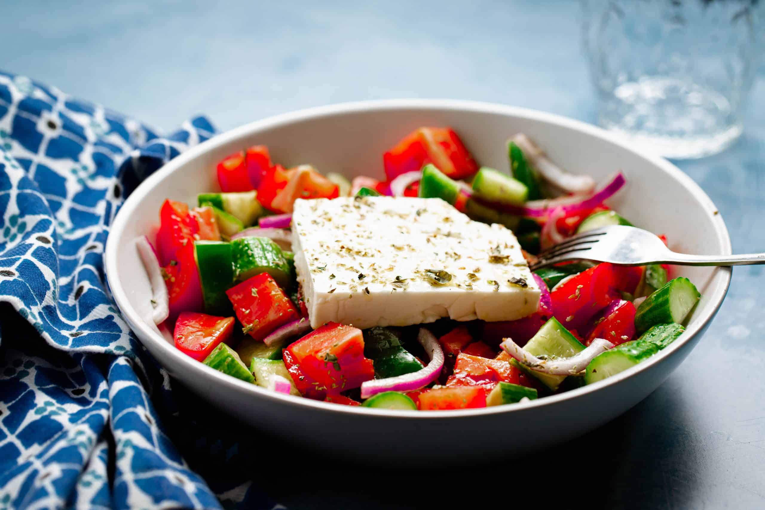 White bowl filled with greek salad