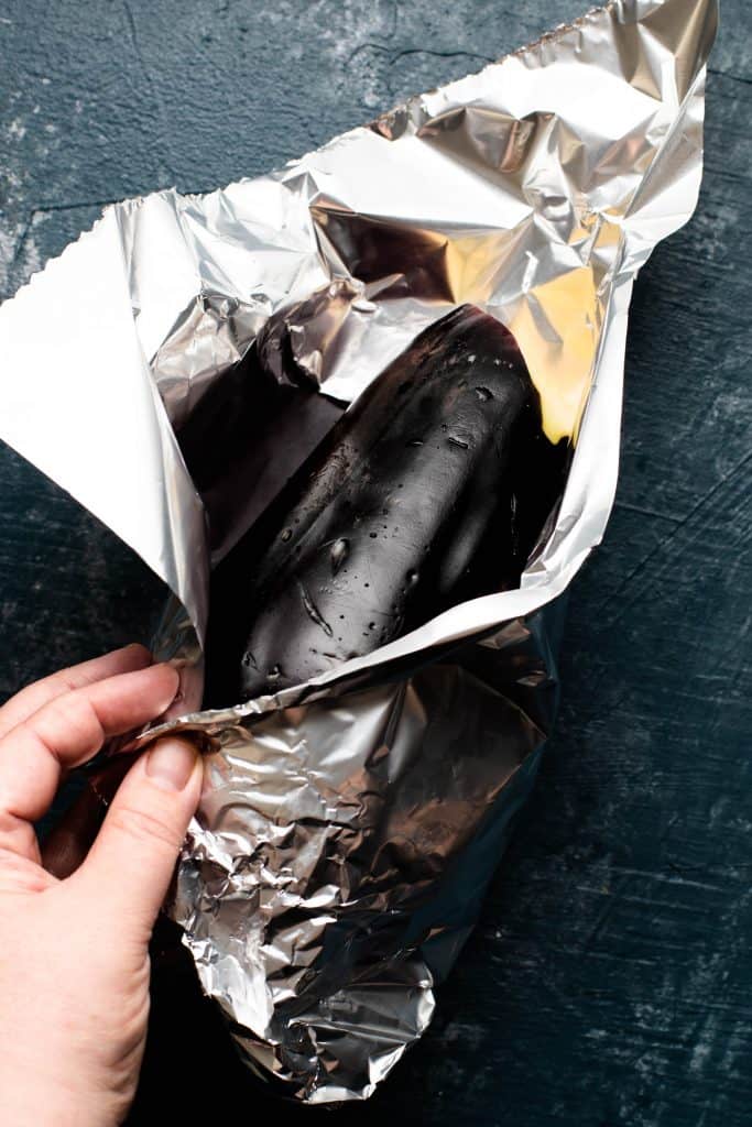 eggplant being wrapped in tin foil