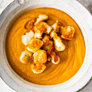 A bowl of roasted butternut squash soup topped with halloumi