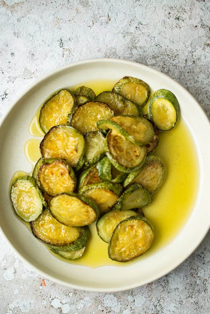 a bowl of fried zucchini and olive oil