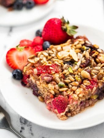 Two white plates with berry baked oatmeal