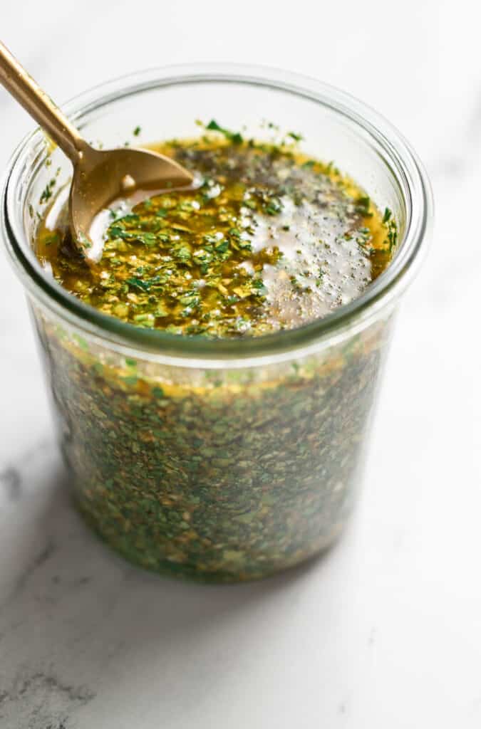 jar of prepared chermoula with a spoon 