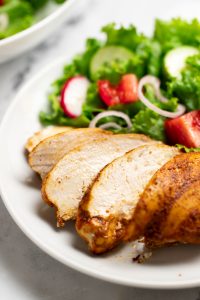 Oven baked Shawarma chicken breast on a plate with salad